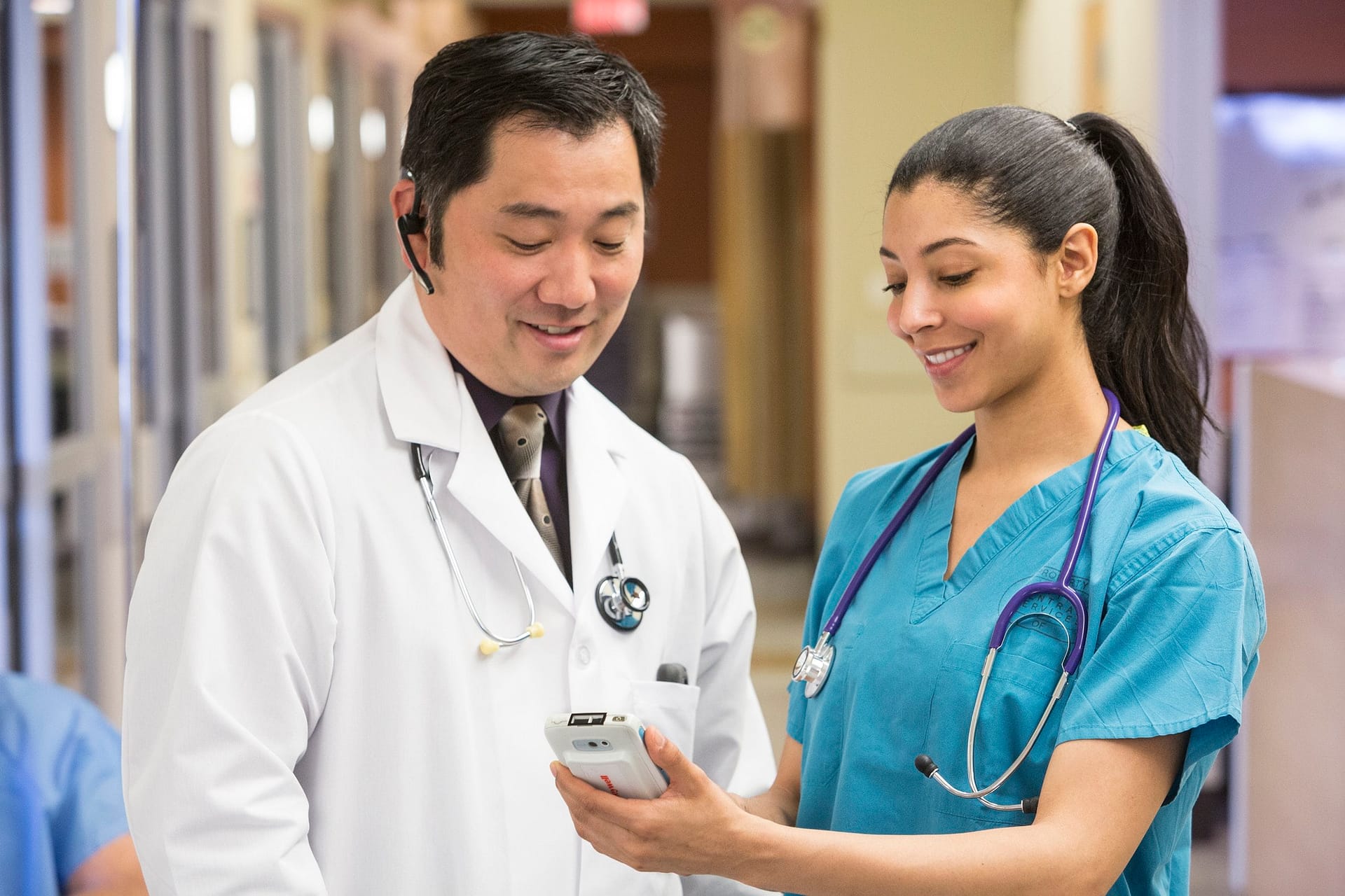 Two doctors looking at a Honeywell mobile computer