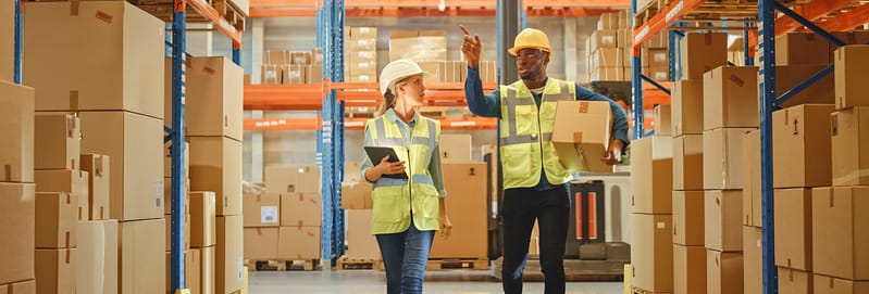 People carrying boxes in the warehouse