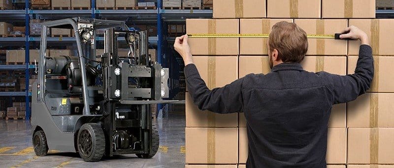 A man measuring packages in a warehouse