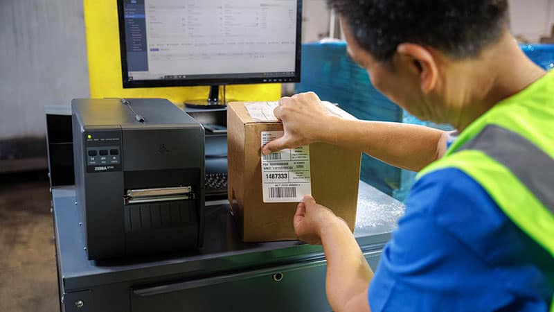 A man using an industrial printer